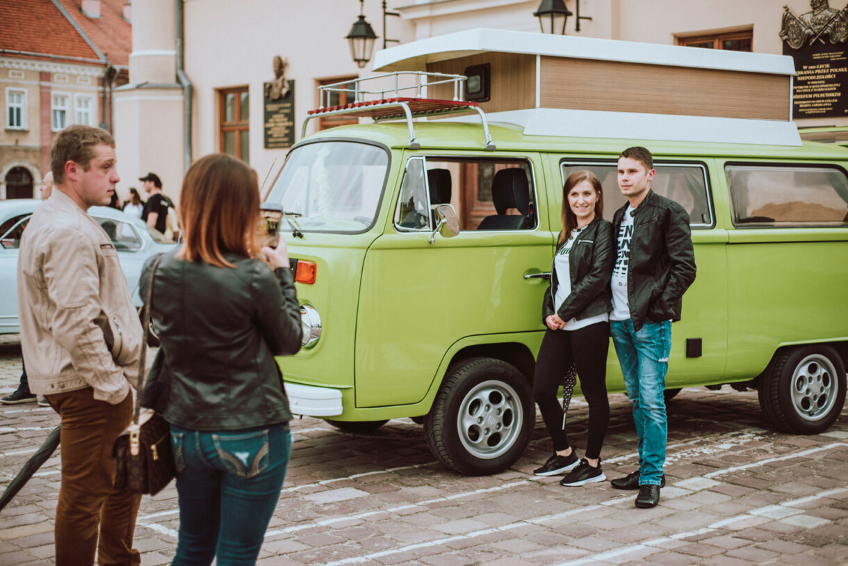 Ludzie pozujący przy samochodzie